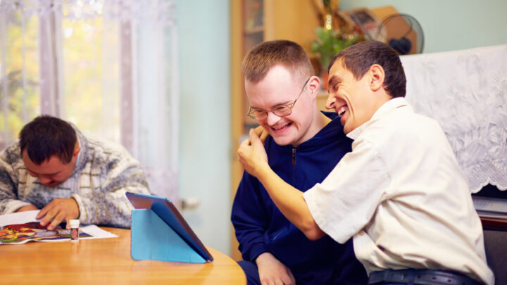 happy friends with disability socializing through internet