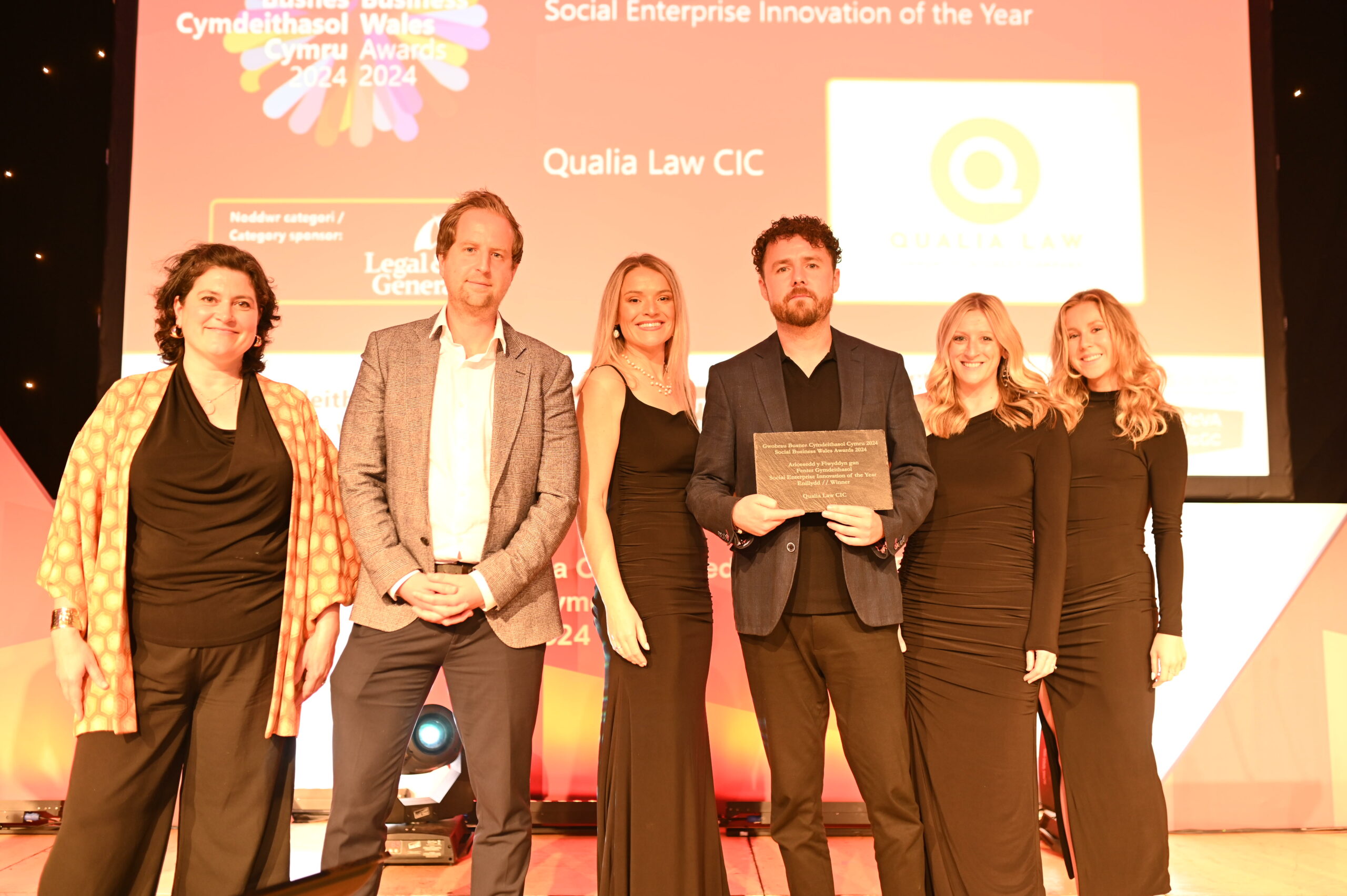 Qualia Law CIC collect their award at the Social Business Wales Awards 2024