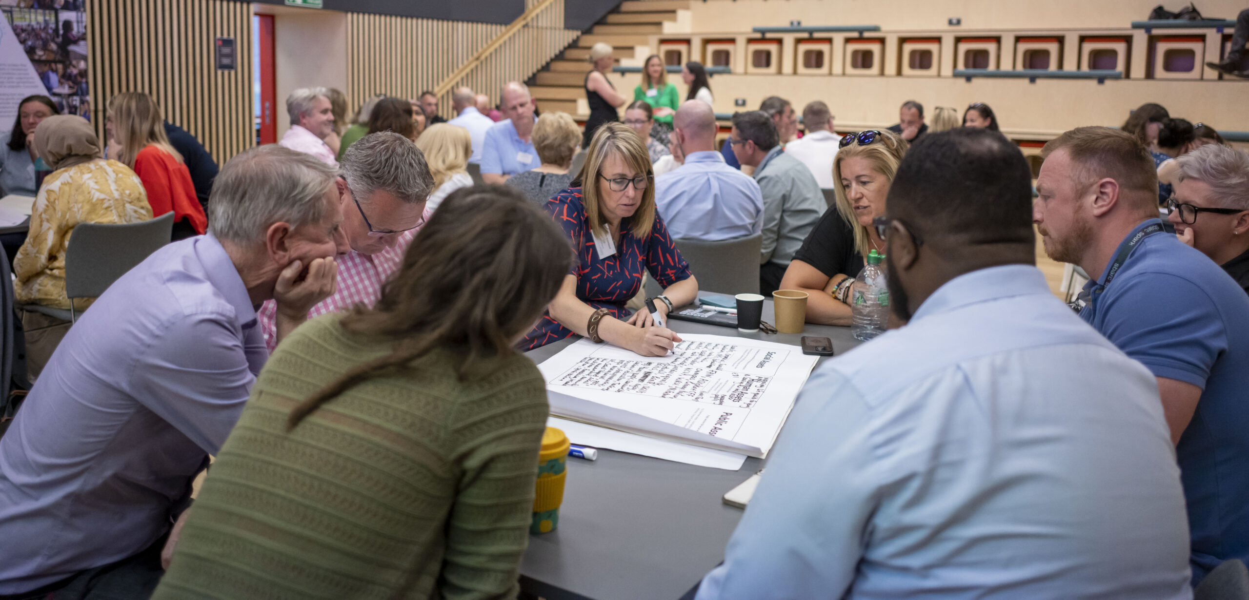 A picture of a Start Something Good Event with people gathered around a table